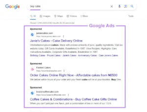 Screenshot showing Google search results for 'buy cake', emphasizing the section labeled 'Google Ads' with three sponsored listings for Janie's Cakes, Fastest Cakes, and Boston Coffee Cake