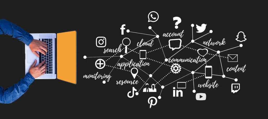 Overhead shot of a person's hands with blue shirt sleeves typing on an open laptop with an orange border. To the right of the laptop, against a black background, is a white digital illustration depicting a network of interconnected social media icons (Instagram logo, Facebook 'f', Twitter bird, Snapchat ghost, LinkedIn 'in', Pinterest 'p') and related digital marketing terms (search, cloud, application, monitoring, resource, account, question mark, speech bubble, network, heart, email icon, content, website, play button, gear icon for communication, smartphone icon). Dotted lines connect the central term 'communication' to various icons and words, visually representing the interconnectedness of digital marketing strategies and social media platforms.